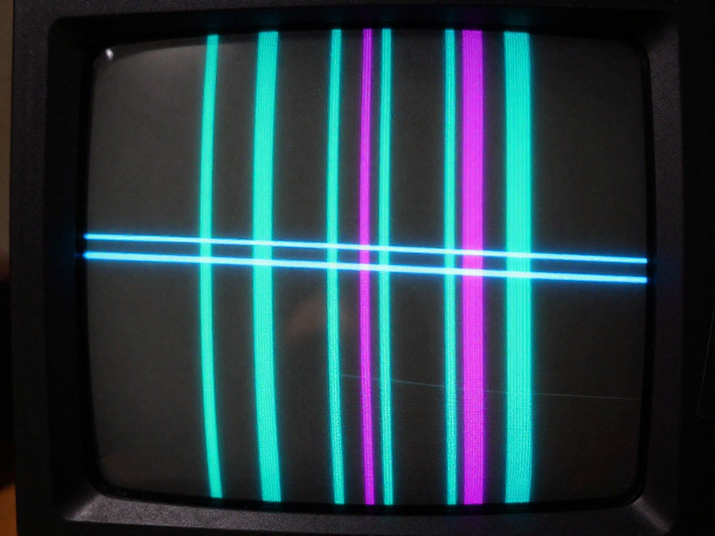 Close-up view of a CRT screen surface showing two thin horizontal damper wires across glowing colored phosphor stripes.